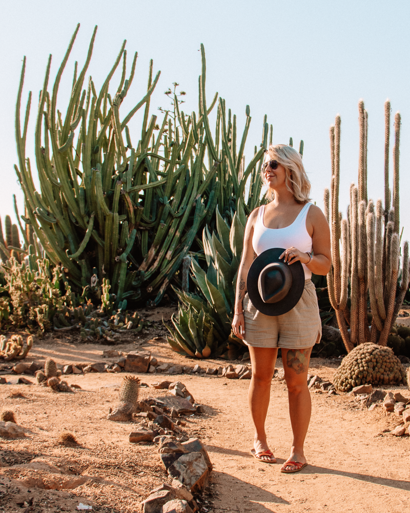 woman standing in front of a large cactus